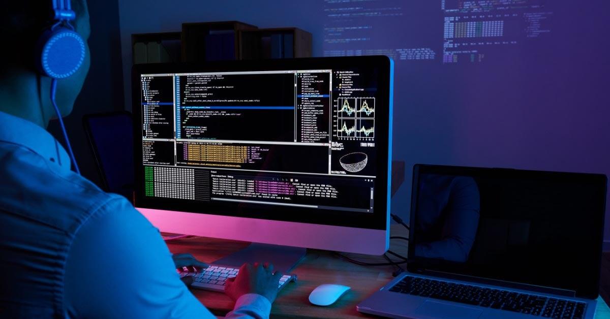 it-specialist-checking-code-computer-dark-office-night.jpg
