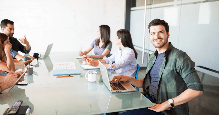 portrait-hispanic-young-man-sitting-with-colleagues-meeting-room.png