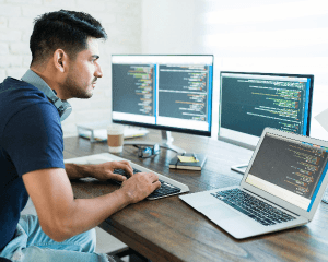 side-view-attractive-hispanic-software-developer-programming-using-computer-while-working-from-home.png