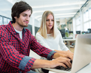 male-female-business-executives-working-laptop.png